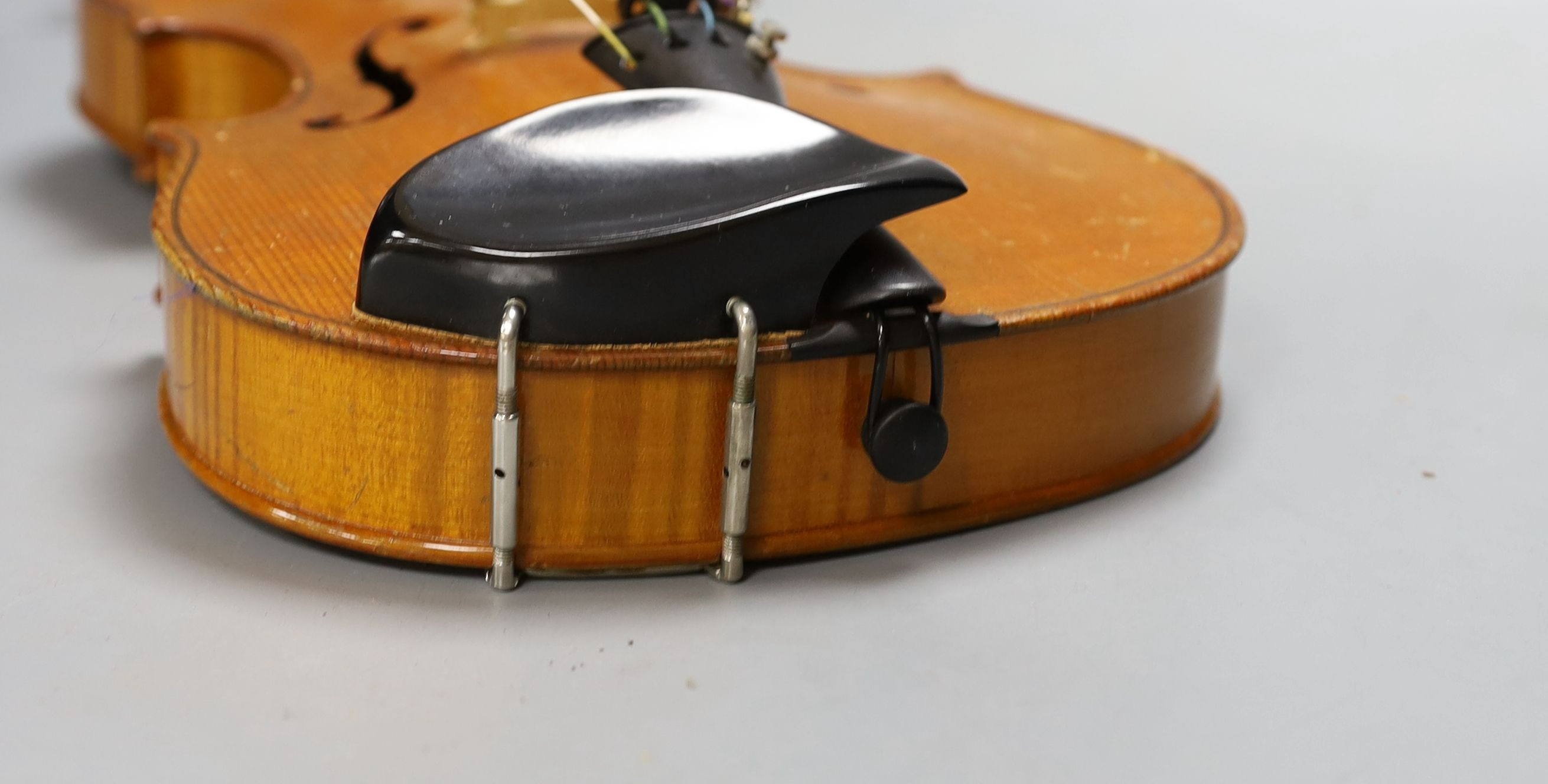 A 20th century violin in case with two bows, length of back 35.5cm